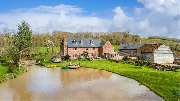 An historic. Grade II Listed farmhouse, converted barn, outbuildings and land in a beautif
