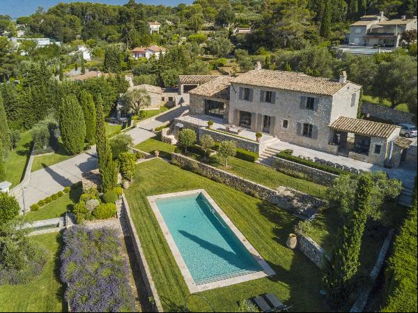 A luxurious stone villa with a pool and sea view in Mougins.