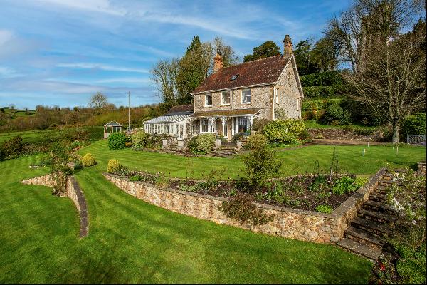 An immaculately presented former vicarage set in a gorgeous garden with views over the bea
