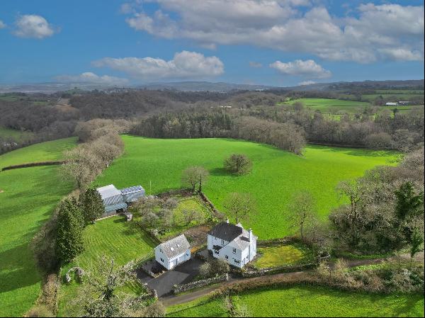 A 1920s family house with annexe set within about 15.5 acres in a private, unspoilt rural 