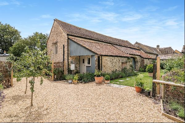 A characterful, converted period barn with a separate guest cottage on the edge of a small