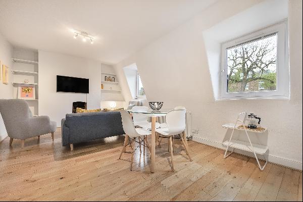 A bright 2 bedroom lateral apartment set on an upper floor with open plan living area to l