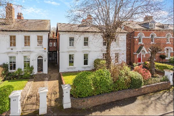 An attractive white stucco townhouse with spacious and characterful accommodation set over