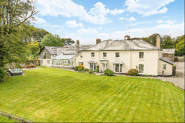 An attractive ringfenced estate extending to over 890 acres with large Georgian Farmhouse,