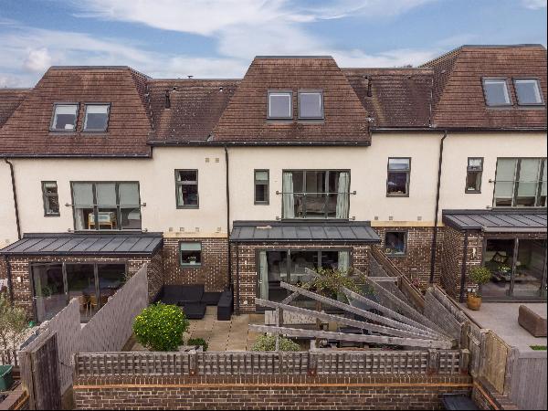 A beautifully presented five bedroom, modern townhouse with sunny gardens and parking, clo