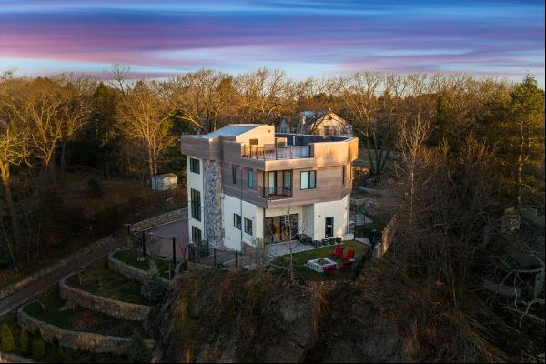 This contemporary masterpiece in Brookline boasts solid, soundproof construction in a tran