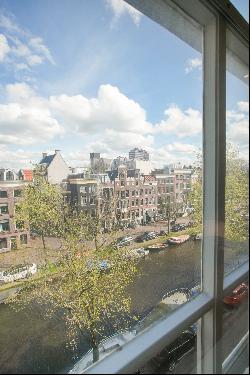 Very charming sunny canal apartment with rooftop terrace, elevator, and parking!