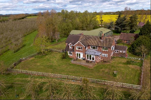 A detached family home with a substantial agricultural outbuilding (complete with a 3 phas