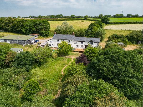 A magnificent detached unlisted farmhouse set in over 8 acres offering exceptional views o