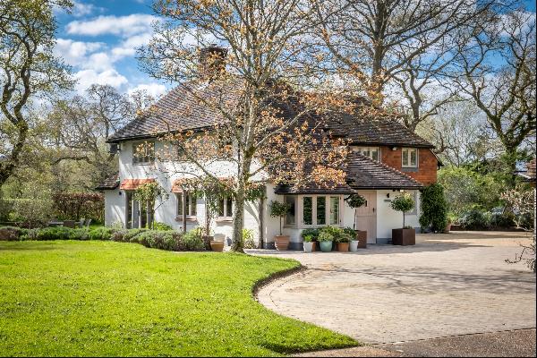 An outstanding family home with outbuildings surrounded by flat gardens in the South Downs