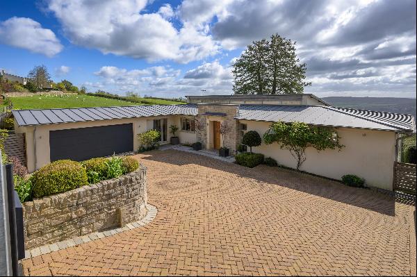 An exceptional, modern, detached family home, with parking, garage, gardens and stunning v