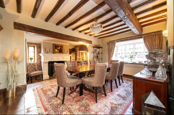 A beautiful period farmhouse with extensive outbuildings sitting at the head of a long dri