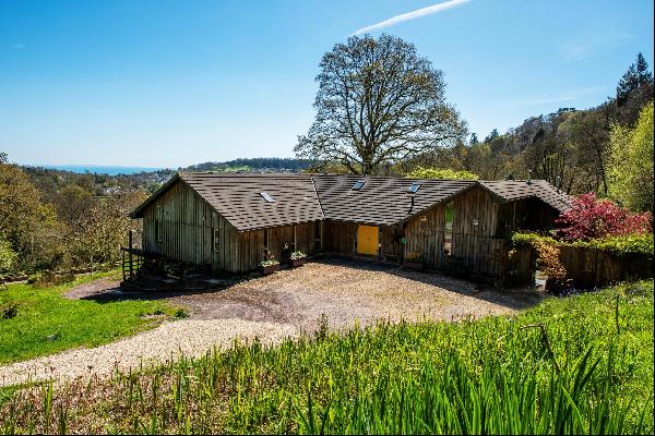 A Dougals Fir-clad house with two studio annexes in 5.5 acres in a private, hillside setti