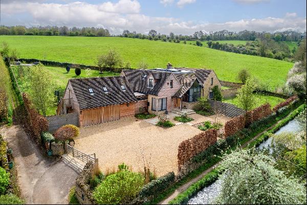 A stunning contemporary home with mature gardens and countryside views.