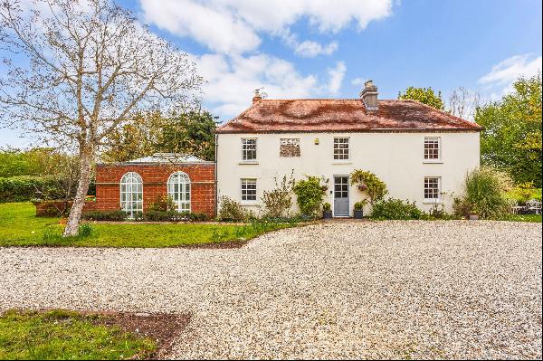 An attractive double-fronted part Georgian house set within grounds of around 1.66 acres i