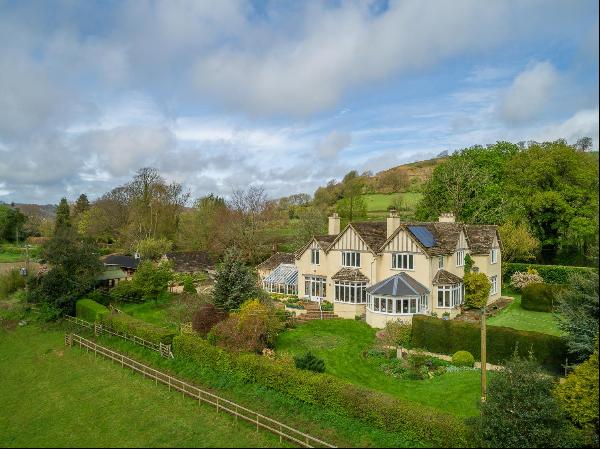 A spacious Edwardian country house with stunning views over its own land with stable yard,