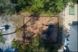 Picturesque lagoon lot with birds and draping oak tree