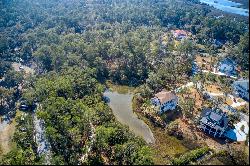 Picturesque lagoon lot with birds and draping oak tree