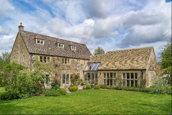 A beautifully presented Cotswold stone village house within a private walled garden, tucke