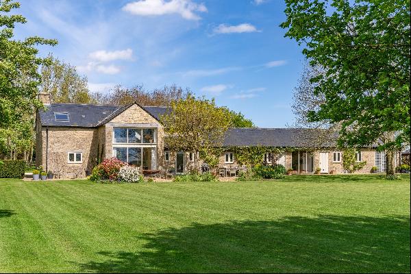A stunning Cotswold stone barn conversion with far-reaching rural views.