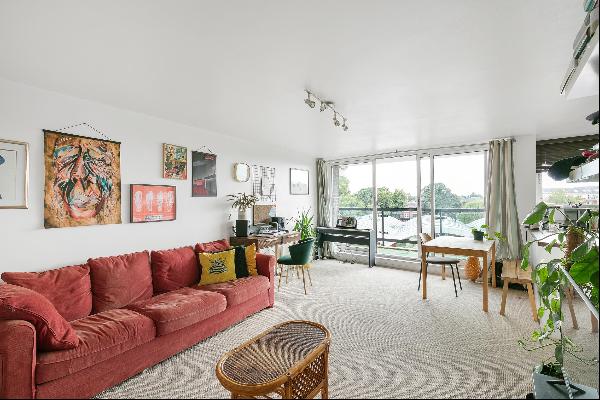 A spacious two bedroom third floor apartment with a balcony and parking, close to Richmond