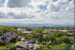 Green, family setting for this property with building potential