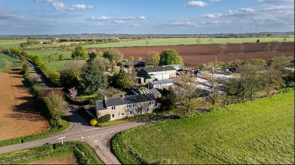 A 4 bedroom detached period farmhouse, with a variety of large outbuildings and land; surr