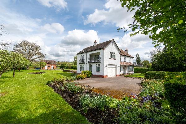 A handsome detached four bedroom family house in a large garden with stables and paddocks.