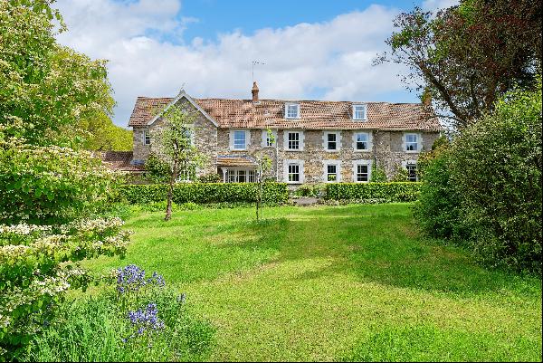 A charming and well presented 19th century house with lovely gardens, adjoining field and 