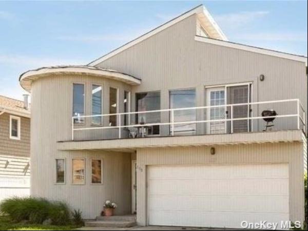 This Contempoary home is located just seconds away from the beach, offering a beachside li