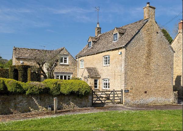 A double fronted period home with annexe overlooking the village green.