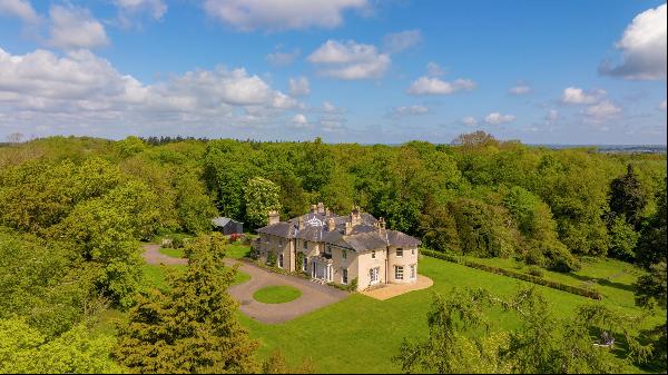 A fine Grade II listed Georgian Country house, with coach house and cottages, set in rolli