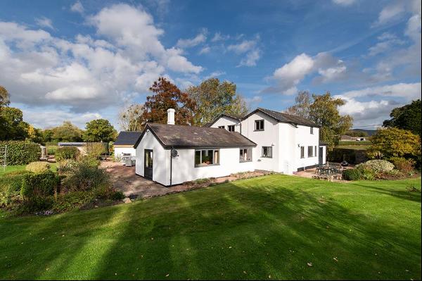 A beautifully refurbished country house with outbuildings, set in about five acres of gard