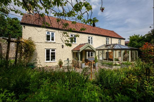 A beautiful 18th century detached family home with sunny gardens,  paddock and copse adjoi