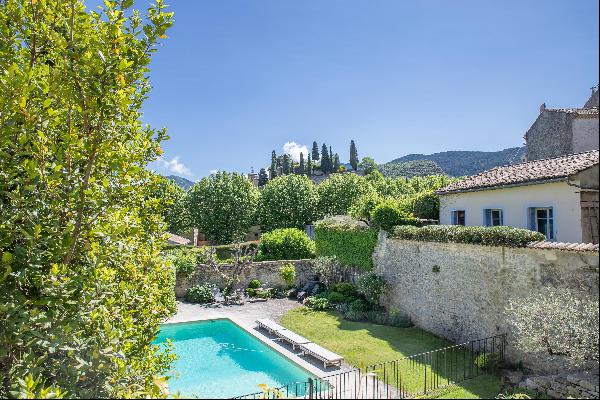 A beautiful stone property with a walled, landscaped garden in the village of Malaucene.