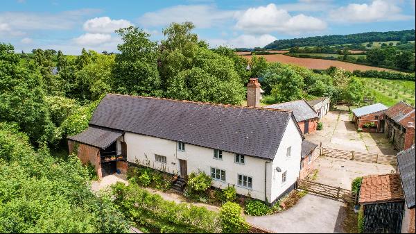 A characterful, period farmhouse with outbuildings and a three acre paddock on the edge of