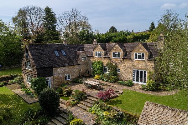 Detached Cotswold stone family home and paddock in idyllic setting.