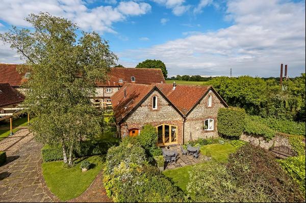 A 19th-century Grade II listed barn conversion in open country within the South Downs Nati