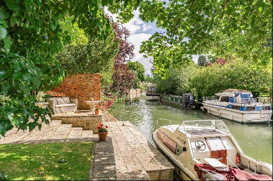 A well-located family home with beautiful gardens backing onto The River Thames..