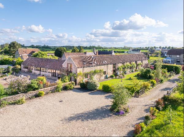 An extensive edge of village barn conversion with secondary accommodation, private garden,