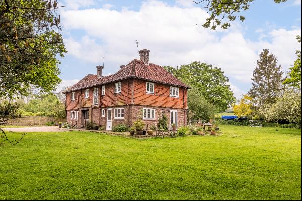 A wonderful rural farmhouse with a substantial barn/garage and 2.48 acres of beautiful mat