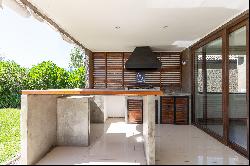 Mediterranean-style house with a terrace featuring an integrated barbecue area.