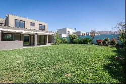 Mediterranean-style house with a terrace featuring an integrated barbecue area.