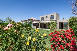 Mediterranean-style house with a terrace featuring an integrated barbecue area.