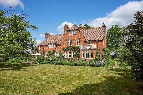 An elegant and substantial former vicarage set in extensive private gardens within easy re