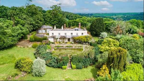 An elegant late-Georgian country house set in over four acres of beautiful, mature gardens