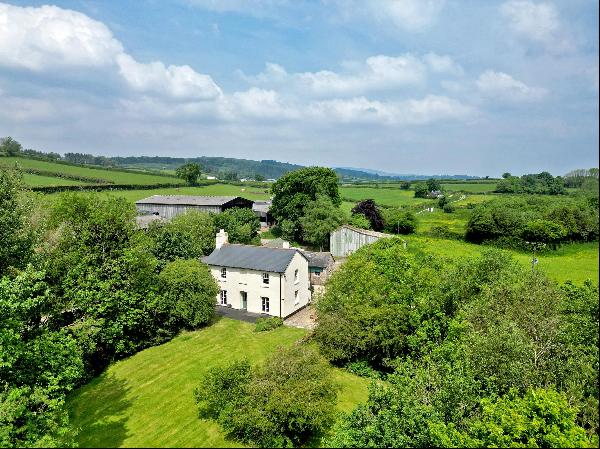 A beautiful farmhouse with land and outbuildings boasting far-reaching views across Dartmo