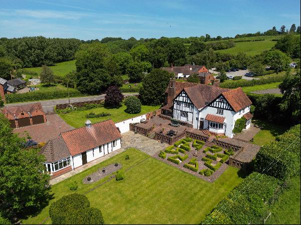 A charming Grade II listed family home in about 1.5 acres, with a triple garage and an ann