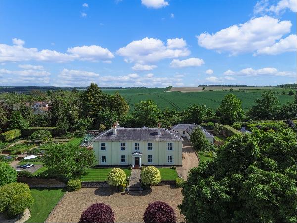 A magnificent village house with secondary accommodation set in delightful formal gardens