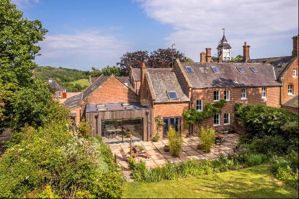 An elegant and beautifully presented Grade II listed family home located in the grounds of